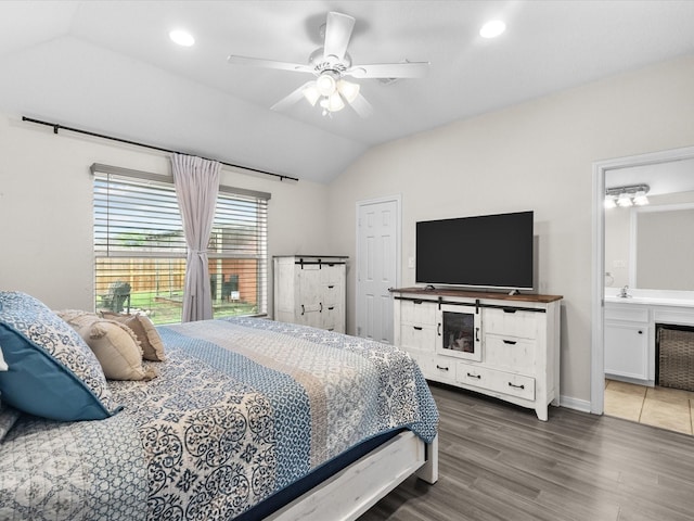 bedroom with connected bathroom, vaulted ceiling, wood finished floors, and recessed lighting