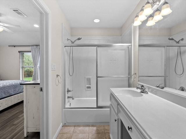 bathroom with vanity, visible vents, a ceiling fan, combined bath / shower with glass door, and ensuite bath