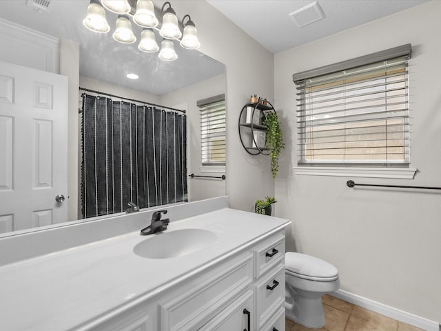 bathroom with tile patterned floors, vanity, an inviting chandelier, toilet, and visible vents