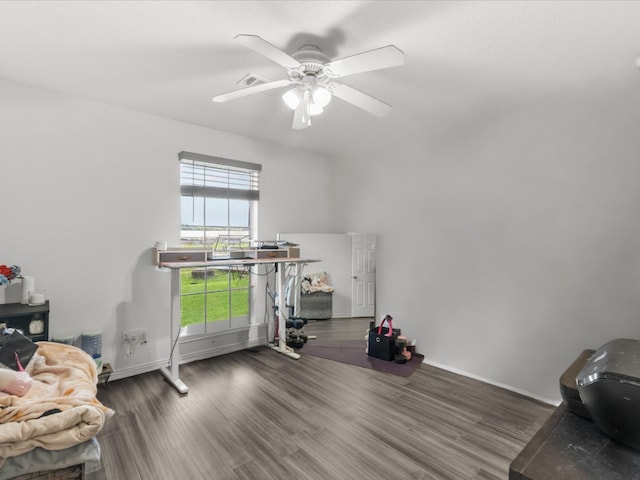 interior space with wood finished floors, visible vents, a ceiling fan, and baseboards