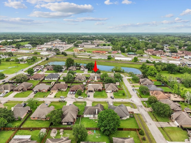drone / aerial view with a residential view and a water view