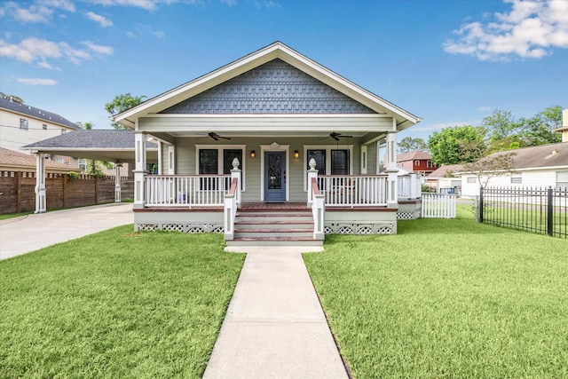 bungalow-style house with fence, ceiling fan, a front yard, covered porch, and driveway