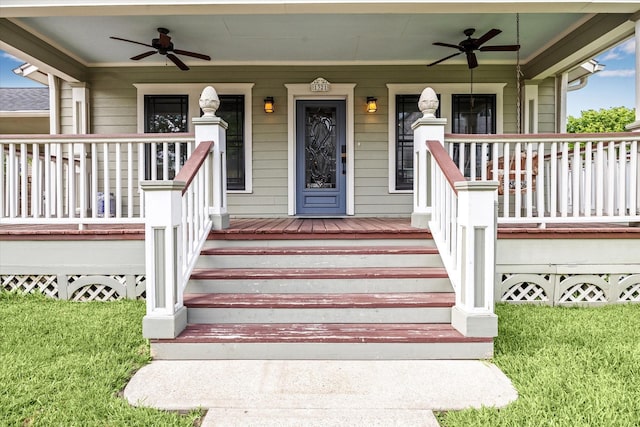 view of exterior entry featuring ceiling fan, a yard, and a porch