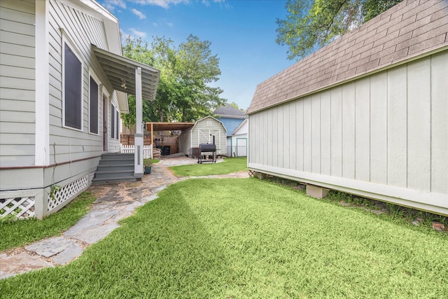 view of yard with a storage shed and an outbuilding