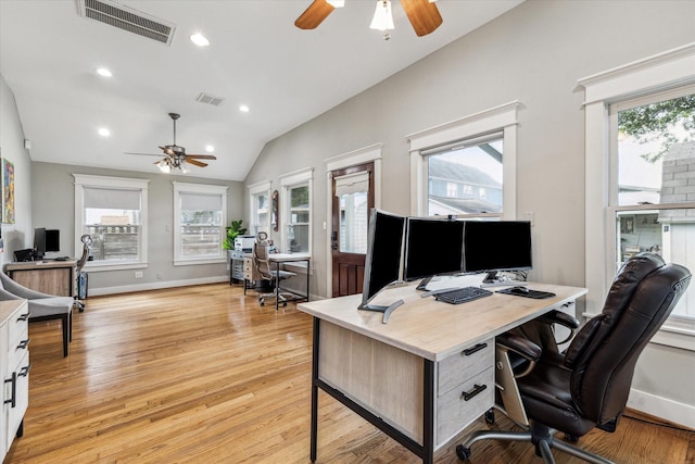office area featuring vaulted ceiling, a ceiling fan, and visible vents