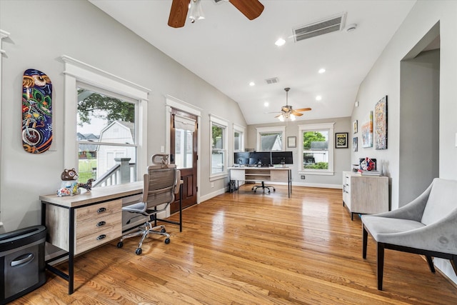 office area featuring visible vents, a ceiling fan, light wood-style flooring, and lofted ceiling