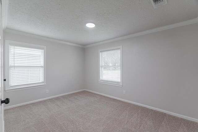 unfurnished room featuring a textured ceiling, carpet floors, visible vents, and baseboards