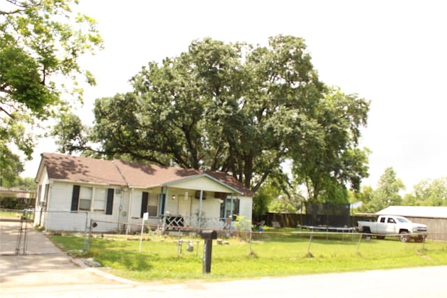 2014 Kowis St, Houston, TX 77093 - ranch-style house featuring a trampoline, a fenced front yard, a front yard, and a gate