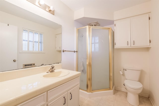 bathroom with vanity, tile patterned flooring, a shower stall, and toilet