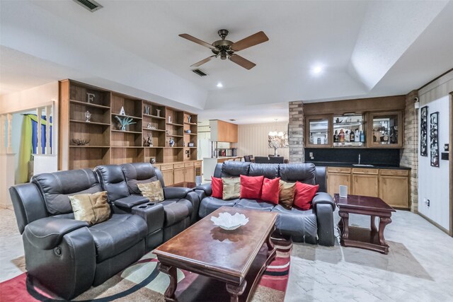 living room featuring lofted ceiling, visible vents, and ceiling fan with notable chandelier
