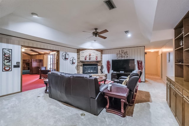 living area featuring light carpet, a ceiling fan, and visible vents