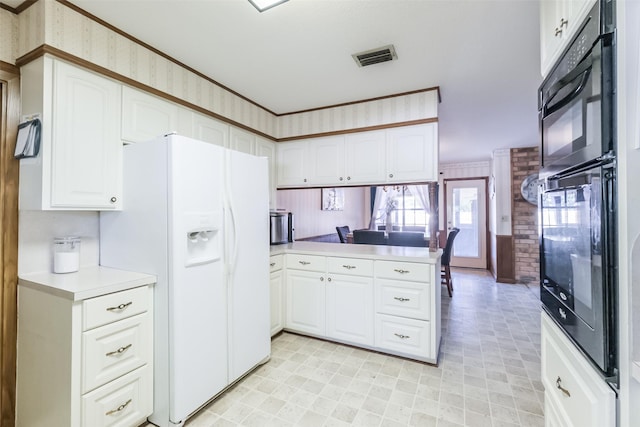 kitchen with white fridge with ice dispenser, light countertops, white cabinets, a peninsula, and visible vents
