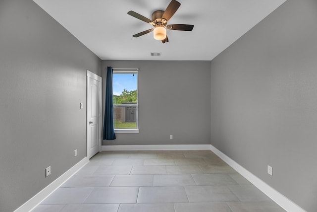 unfurnished room with baseboards, ceiling fan, light tile patterned flooring, and visible vents