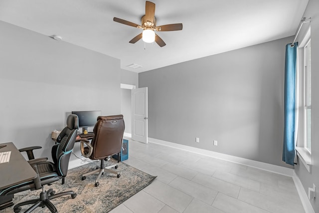 office area featuring light tile patterned floors, baseboards, and a ceiling fan