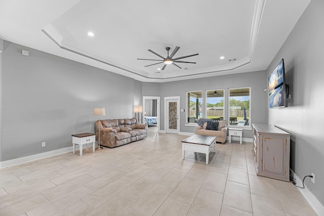 living area featuring ceiling fan, a tray ceiling, recessed lighting, and visible vents