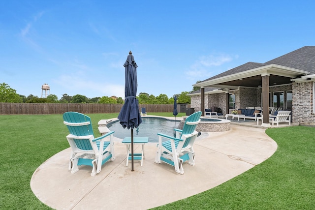 view of patio with a fenced backyard, an outdoor living space with a fire pit, and a pool with connected hot tub