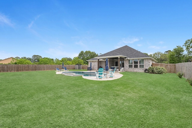 view of yard with a fenced in pool, a fenced backyard, and a patio area