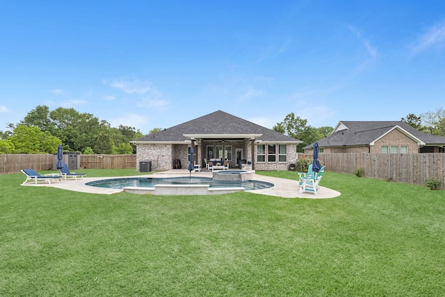 back of property with a fenced backyard, a yard, a patio area, and brick siding
