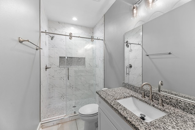 full bathroom with vanity, a marble finish shower, and toilet