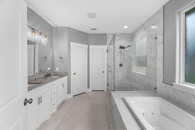 full bath featuring a tub with jets, visible vents, a marble finish shower, and a wealth of natural light