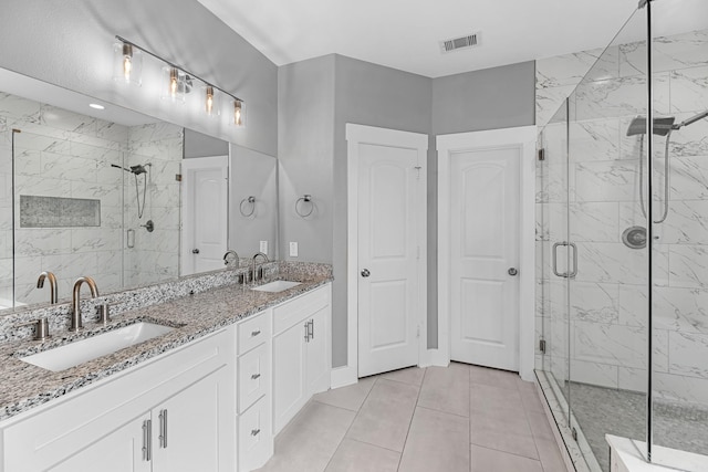 full bathroom featuring visible vents, a marble finish shower, and a sink