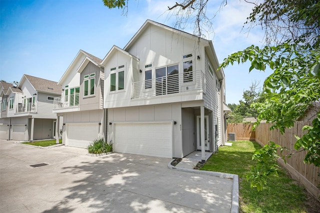 861 Prosper St, Houston, TX 77088 - view of property with a balcony, driveway, board and batten siding, an attached garage, and fence