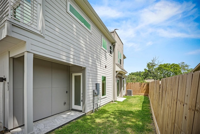 861 Prosper St, Houston, TX 77088 - view of side of home with a fenced backyard, central air condition unit, and a yard