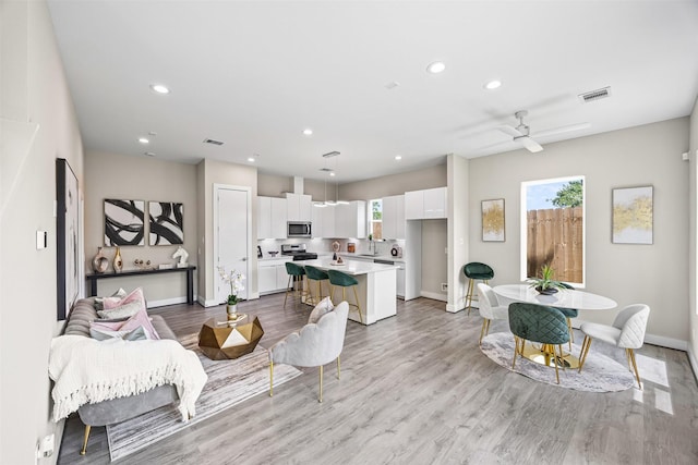 861 Prosper St, Houston, TX 77088 - living area with recessed lighting, visible vents, light wood finished floors, and baseboards