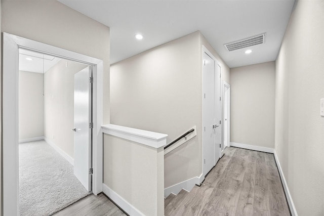 861 Prosper St, Houston, TX 77088 - corridor featuring light wood-type flooring, baseboards, visible vents, recessed lighting, and an upstairs landing