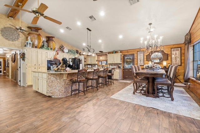 dining space with recessed lighting, light wood-type flooring, visible vents, and ceiling fan with notable chandelier