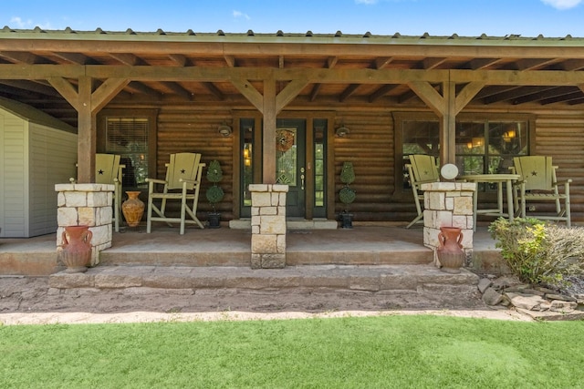 property entrance with log exterior and covered porch