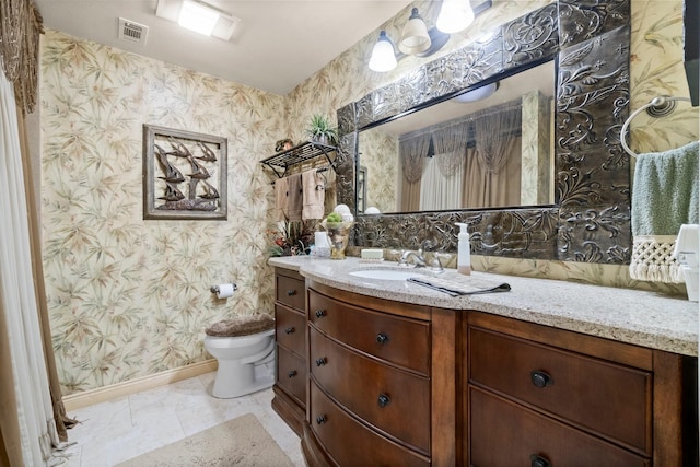 bathroom with wallpapered walls, vanity, baseboards, toilet, and visible vents