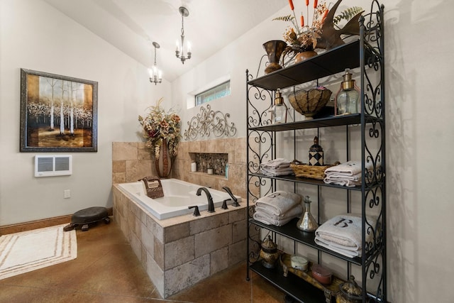 bathroom featuring lofted ceiling, visible vents, baseboards, a garden tub, and a notable chandelier