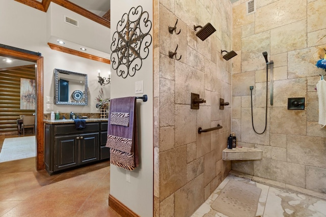 bathroom featuring baseboards, visible vents, vanity, and tiled shower