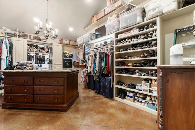 spacious closet with an inviting chandelier and light tile patterned flooring