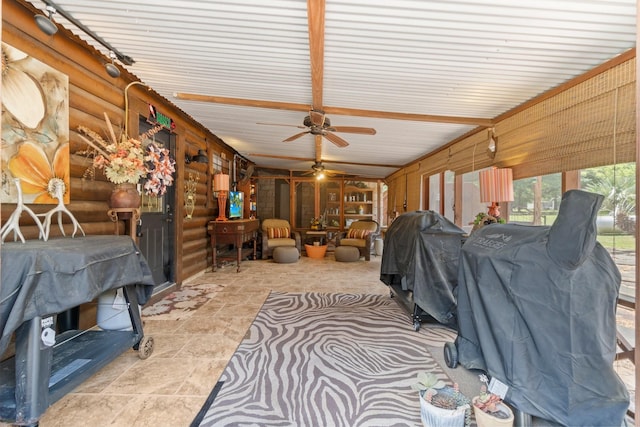 sunroom / solarium featuring stone finish flooring, log walls, and ceiling fan
