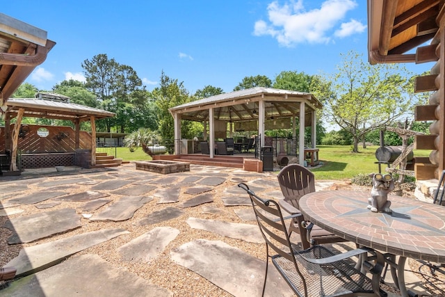 view of patio featuring a gazebo and outdoor dining space