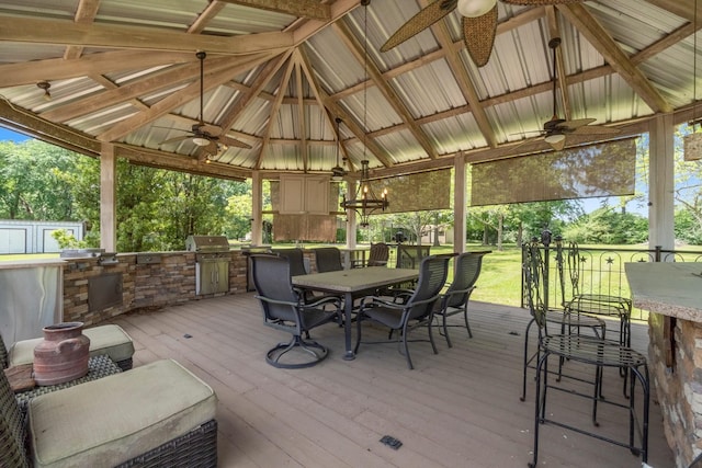sunroom / solarium featuring exterior kitchen, outdoor dining area, and ceiling fan