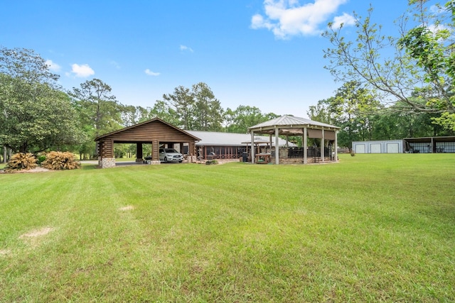 view of yard with an outdoor structure, a gazebo, and a detached carport