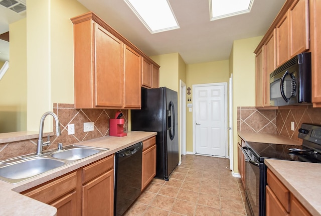 14418 Birch Knoll Ln, Houston, TX 77047 - kitchen with black appliances, a sink, decorative backsplash, light countertops, and baseboards