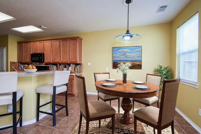 14418 Birch Knoll Ln, Houston, TX 77047 - dining area with dark tile patterned flooring and baseboards