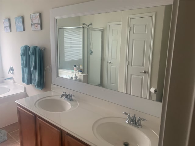 14418 Birch Knoll Ln, Houston, TX 77047 - bathroom featuring a stall shower, double vanity, a bath, and tile patterned flooring
