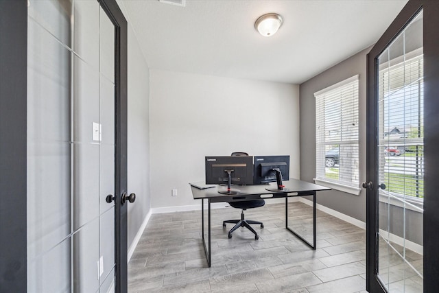 office area featuring baseboards, wood finished floors, and french doors