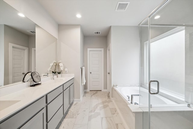 full bath with visible vents, recessed lighting, a garden tub, and marble finish floor