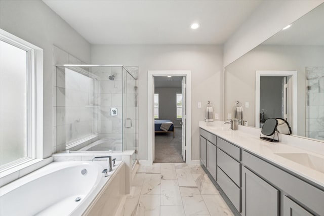 ensuite bathroom with a shower stall, ensuite bath, marble finish floor, double vanity, and a garden tub