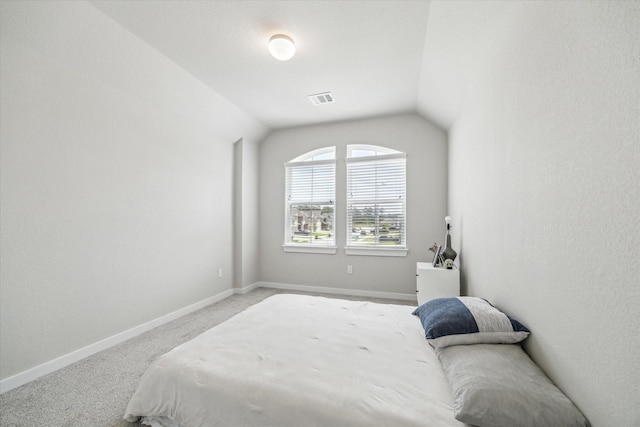carpeted bedroom with baseboards, visible vents, and lofted ceiling