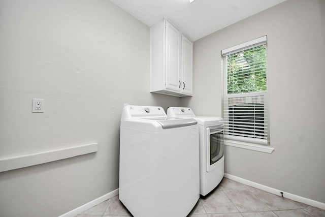 14110 Withersdale Dr, Houston, TX 77077 - laundry room featuring cabinet space, washer and dryer, baseboards, and light tile patterned floors