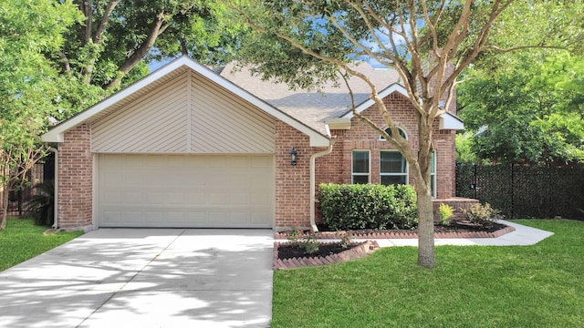 single story home with brick siding, a garage, a front yard, and concrete driveway