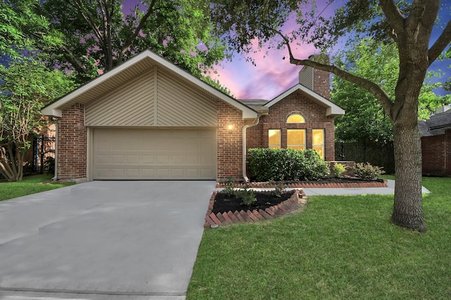 view of front of home featuring brick siding, an attached garage, driveway, and a chimney