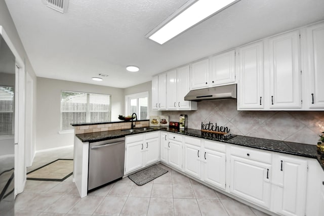 kitchen featuring visible vents, stainless steel dishwasher, black electric cooktop, a sink, and under cabinet range hood